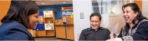 a fulton bank teller helping two customers