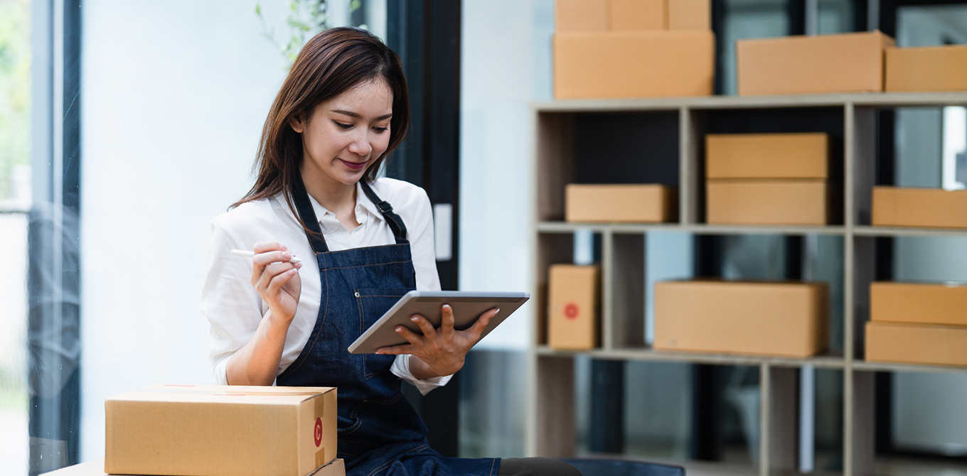 a small business owner on her tablet in a warehouse